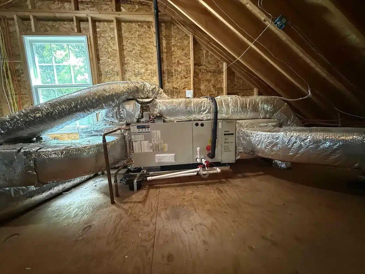 New hydro-air handler connected to insulated ductwork in a Milford, CT attic, installed by Celco with a Lennox air conditioner