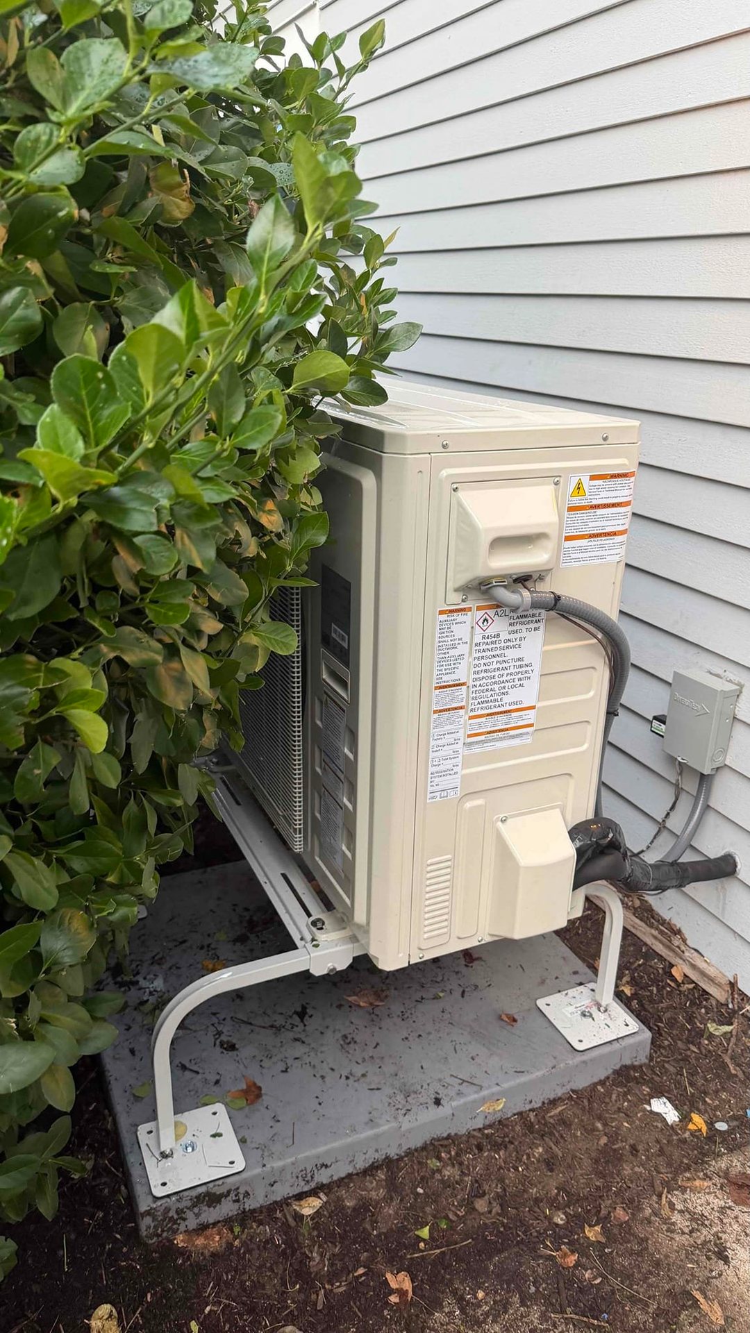 High-efficiency heat pump outdoor unit installed beside a Norwalk home by Celco