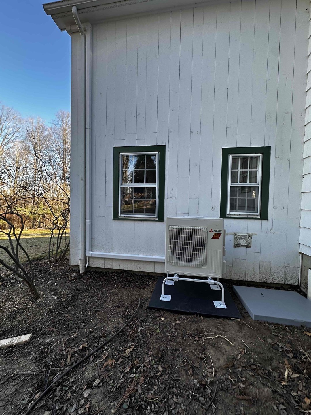 Mitsubishi Electric H2i heat pump installed on a pad at a Wilton home by Celco